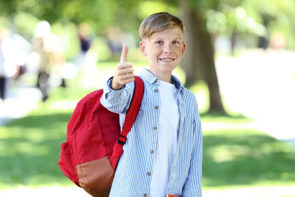 Boy w/ Braces Giving Thumbs Up
